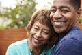 Happy senior African American woman and her middle aged son embracing, head and shoulders, close up