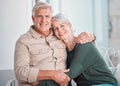 Happy senior caucasian couple bonding at home. Mature husband and wife hugging while relaxing together. Happy and Royalty Free Stock Photo