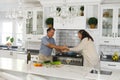 Happy senior caucasian couple in modern kitchen, dancing together and smiling Royalty Free Stock Photo