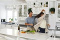 Happy senior caucasian couple in modern kitchen, dancing together and smiling Royalty Free Stock Photo