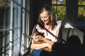 Happy senior caucasian woman in bedroom, holding her pet cat Royalty Free Stock Photo