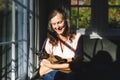 Happy senior caucasian woman in bedroom, holding her pet cat Royalty Free Stock Photo