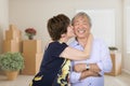Happy Senior Chinese Couple Inside Empty Room with Moving Boxes