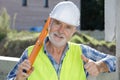 Happy senior construction worker looking at camera