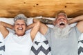 Happy senior couple in bed - Hipster mature people having funny bed time together