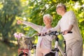 Happy senior couple with bicycles at summer park Royalty Free Stock Photo