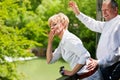 Happy senior couple on bridge waving hands Royalty Free Stock Photo