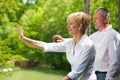 Happy senior couple on bridge waving hands Royalty Free Stock Photo