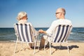 Happy senior couple in chairs on summer beach Royalty Free Stock Photo