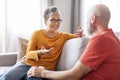 Happy Senior Couple Chatting While Relaxing Together On Couch In Living Room Royalty Free Stock Photo