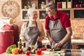 Happy senior couple cooking together on kitchen Royalty Free Stock Photo