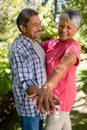 Happy senior couple dancing in garden Royalty Free Stock Photo