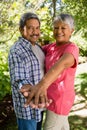 Happy senior couple dancing in garden on a sunny day Royalty Free Stock Photo