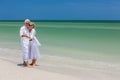 Happy Senior Couple Dancing Holding Hands on A Tropical Beach Royalty Free Stock Photo