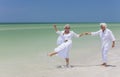 Happy Senior Couple Dancing Holding Hands on A Tropical Beach Royalty Free Stock Photo