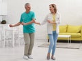 Happy senior couple dancing in kitchen Royalty Free Stock Photo