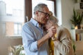 Happy senior couple dancing in living room Royalty Free Stock Photo