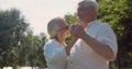 Happy senior couple dancing in summer park Royalty Free Stock Photo