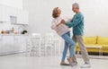 Happy senior couple dancing in kitchen Royalty Free Stock Photo