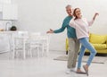 Happy senior couple dancing in kitchen Royalty Free Stock Photo