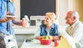 Happy senior couple doing breakfast inside vintage bar restaurant in morning time - Joyful elderly and healthy lifestyle concept Royalty Free Stock Photo