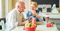 Happy senior couple doing breakfast inside vintage bar restaurant in morning time - Joyful elderly, love and healthy lifestyle Royalty Free Stock Photo