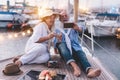 Happy senior couple doing selfie, cheering with champagne on a sailboat during anniversary vacation - Joyful elderly lifestyle,