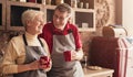 Happy senior couple drinking coffee at kitchen, panorama Royalty Free Stock Photo