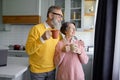 Happy senior couple drinking coffee or tea on home kitchen Royalty Free Stock Photo