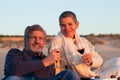 Happy senior couple drinking red wine at seashore Royalty Free Stock Photo