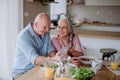 Happy senior couple eating dinner together at home. Royalty Free Stock Photo