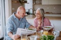 Happy senior couple eating dinner together at home. Royalty Free Stock Photo