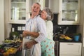 Happy senior couple embracing in kitchen Royalty Free Stock Photo