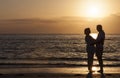 Happy Senior Couple Embracing on Sunset Beach Royalty Free Stock Photo