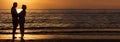 Happy Senior Couple Embracing on Sunset Beach Panorama Royalty Free Stock Photo