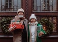 Happy senior couple enjoying christmas market, buying gifts and christmas tree. Royalty Free Stock Photo