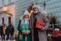 Happy senior couple enjoying christmas market, buying gifts and christmas tree. Royalty Free Stock Photo