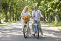 Happy Senior Couple Enjoying Cycle Ride In Summer Park Royalty Free Stock Photo