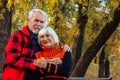 Happy senior couple enjoying each other in the park. Support and care from a loved one, warm emotions