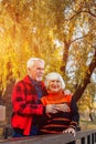 Happy senior couple enjoying each other in the park. Support and care from a loved one, warm emotions