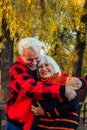 Happy senior couple enjoying each other in the park. Support and care from a loved one, warm emotions