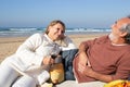 Happy senior couple enjoying romantic picnic at seashore Royalty Free Stock Photo