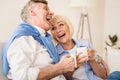 Happy senior couple enjoying tea and laughing Royalty Free Stock Photo