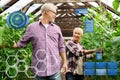 Happy senior couple at farm greenhouse Royalty Free Stock Photo