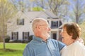 Happy Senior Couple in Front Yard of House