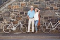 Happy senior couple going for a bike ride in the city Royalty Free Stock Photo