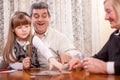 Happy senior couple with granddaughter playing cards Royalty Free Stock Photo