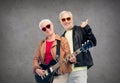 Happy senior couple with guitar showing thumbs up Royalty Free Stock Photo