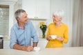 Happy senior couple having coffee in kitchen Royalty Free Stock Photo