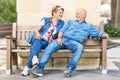 Happy senior couple having fun on a bench - Concept of active pl Royalty Free Stock Photo